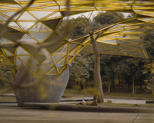 A person enjoying a relaxed morning walk in a modern urban park in Kuala Lumpur